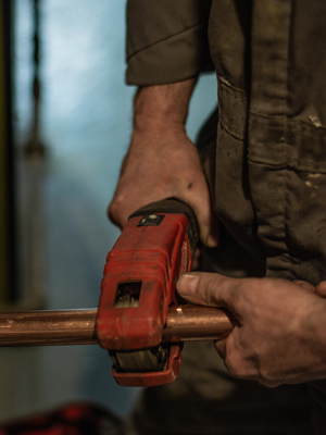 cutting pipe to run new boiler lines for infloor