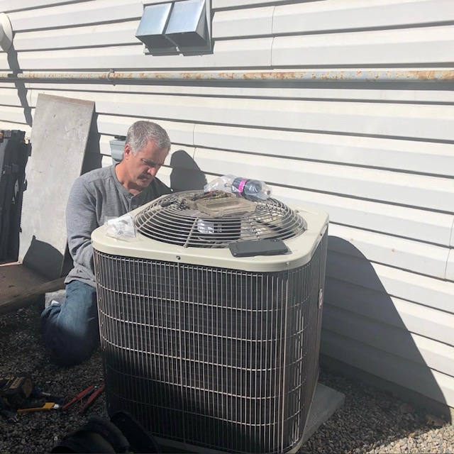 Geoff fixing a condensor on a residential air conditioner in Airdrie